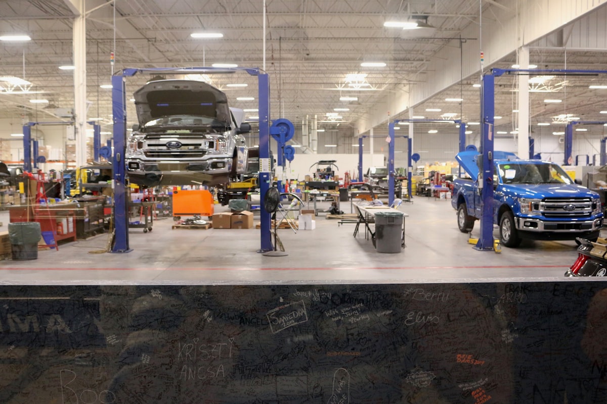 Interior of an auto repair shop with cars on lifts