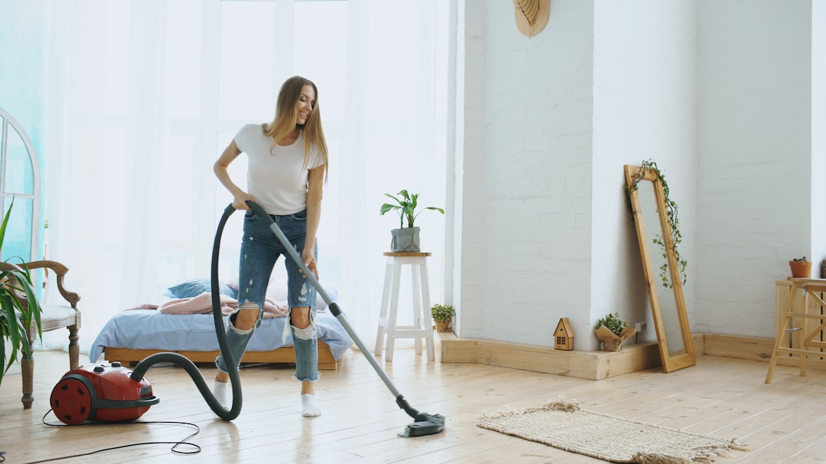 Woman vacuuming a living room floor