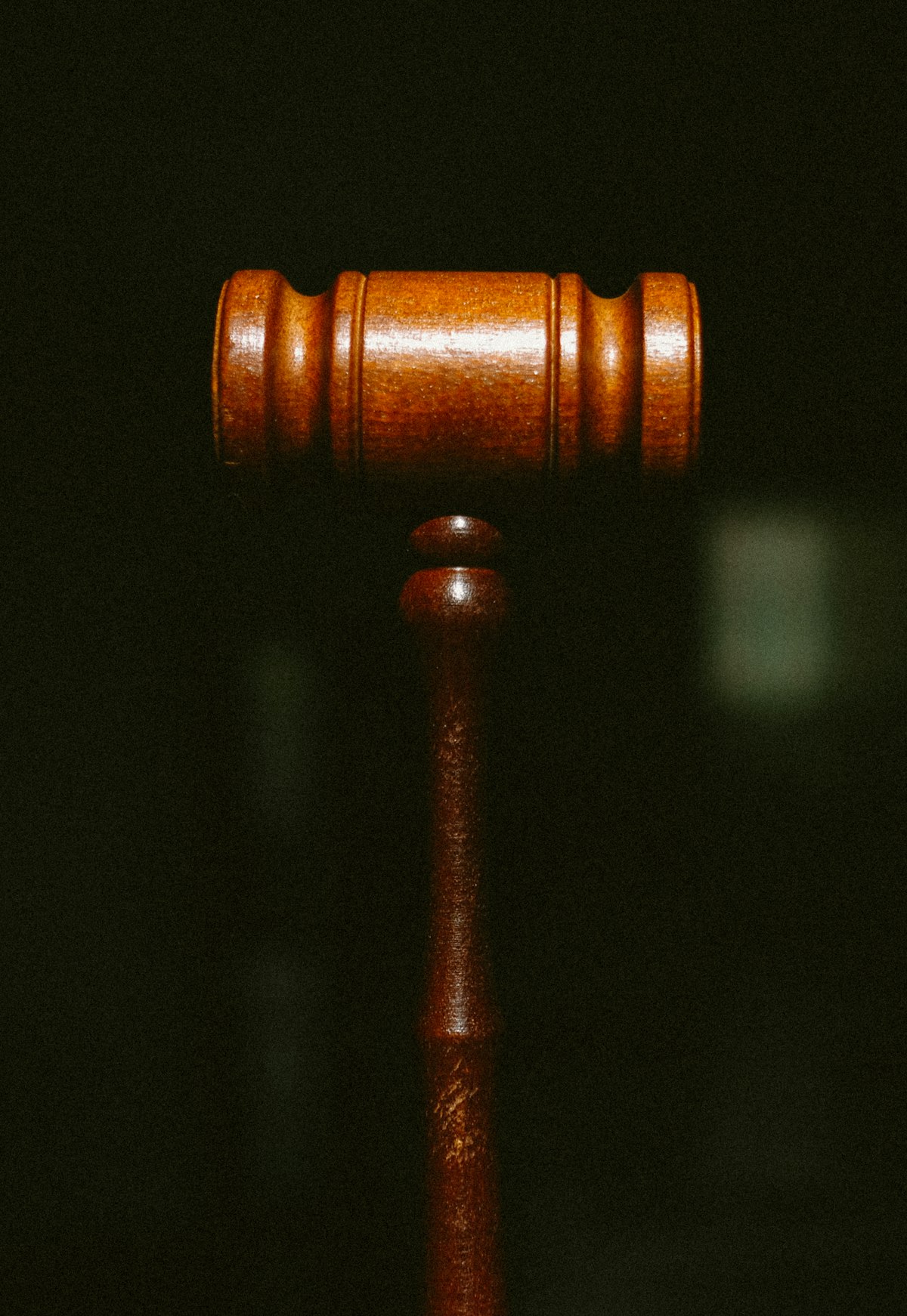 A wooden judge's gavel on a dark background