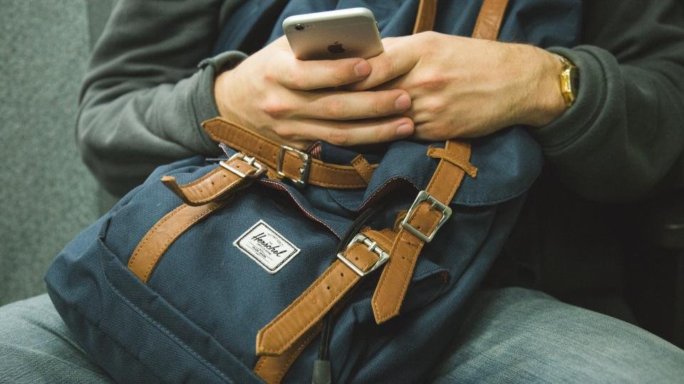 A person holding a smartphone, ready to open a Google review link